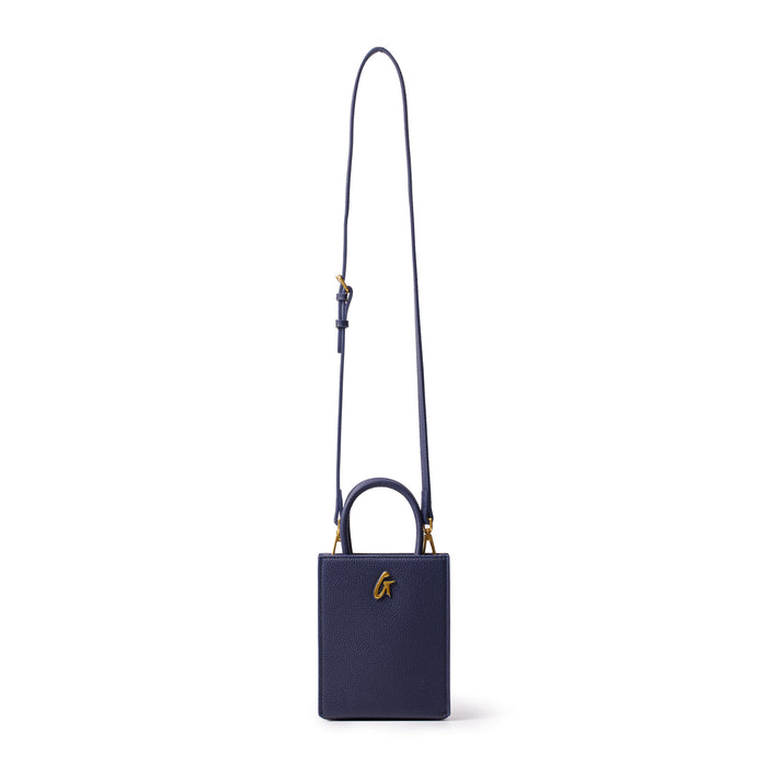 Mini pebble navy tote bag with a gold "G" logo, featuring a small rectangular shape and a long adjustable strap.