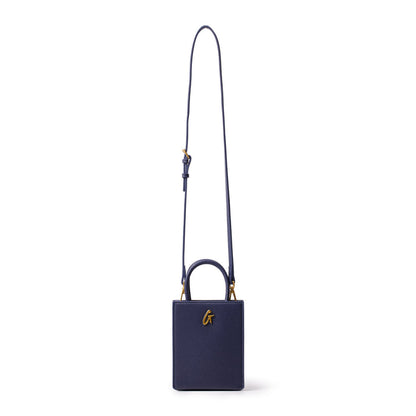 Mini pebble navy tote bag with a gold "G" logo, featuring a small rectangular shape and a long adjustable strap.