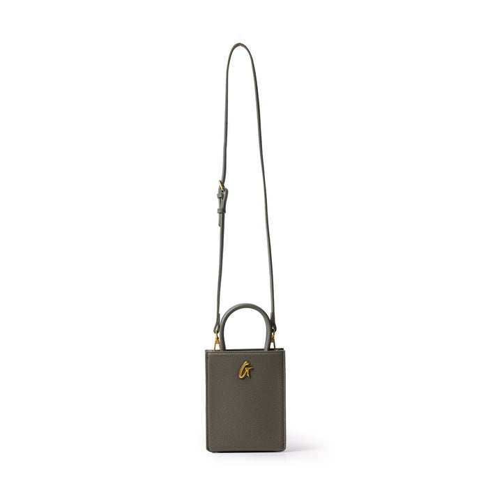 Mini pebble tote bag in olive green with a gold "G" logo, featuring a top handle and adjustable shoulder strap.