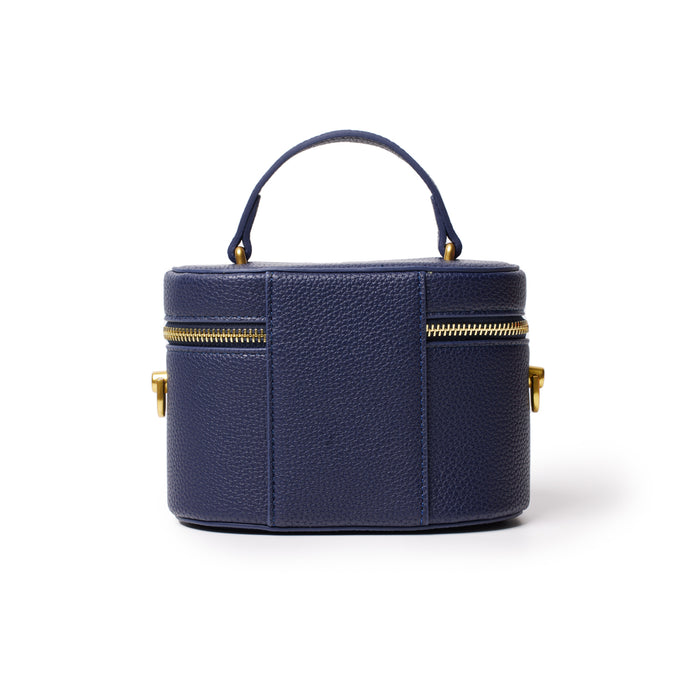 Mini navy pebble leather vanity bag with gold zipper and top handle, compact and stylish for travel essentials.