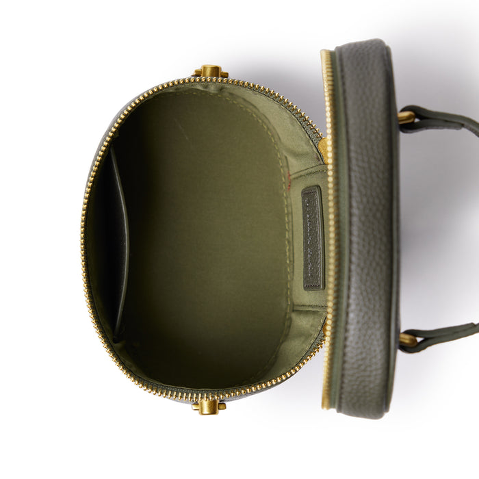 Olive green mini pebble vanity bag with gold zipper, open to show interior compartments and lining.