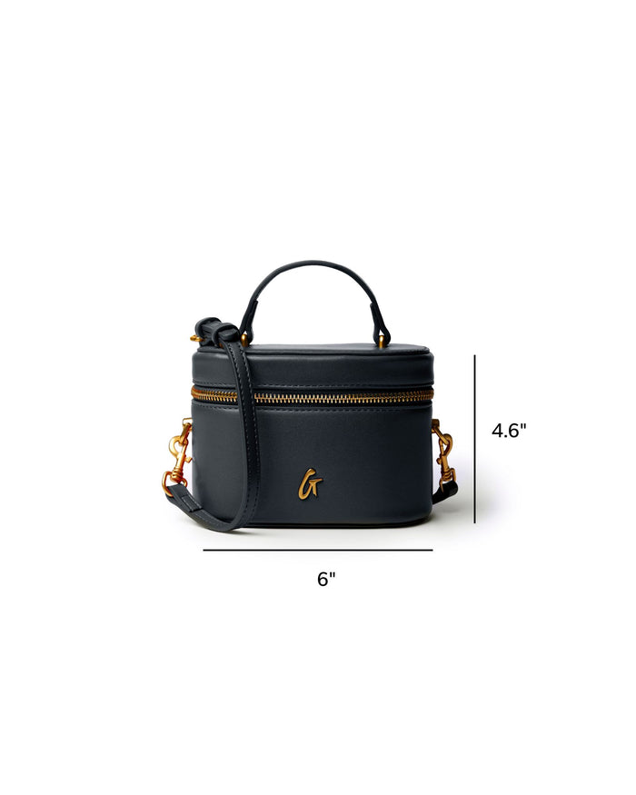 Mini smooth gold vanity bag in black with a top handle and adjustable strap, featuring gold zipper accents.