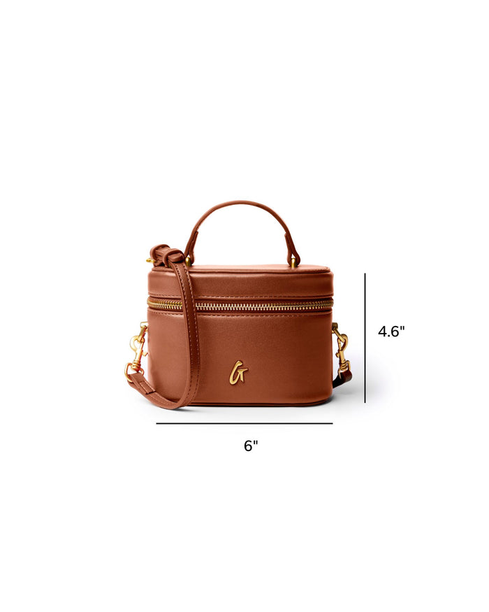 Mini smooth gold vanity bag in brown with a top handle and adjustable strap, perfect for stylish organization.