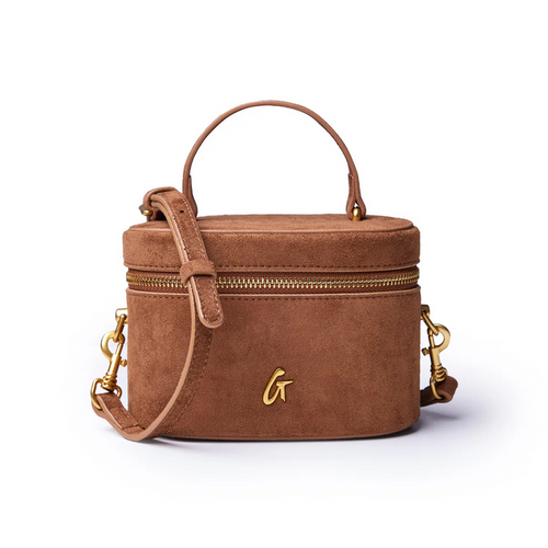 Brown mini suede vanity bag with a top handle, gold zipper, and detachable shoulder strap. Ideal for stylish organization.