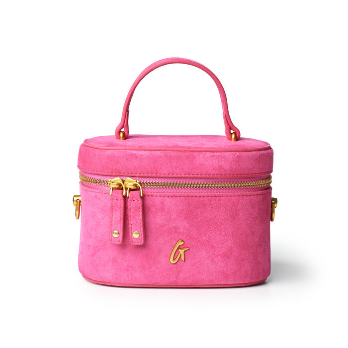 Hot pink mini suede vanity bag with gold zippers and handle, perfect for stylish organization on the go.