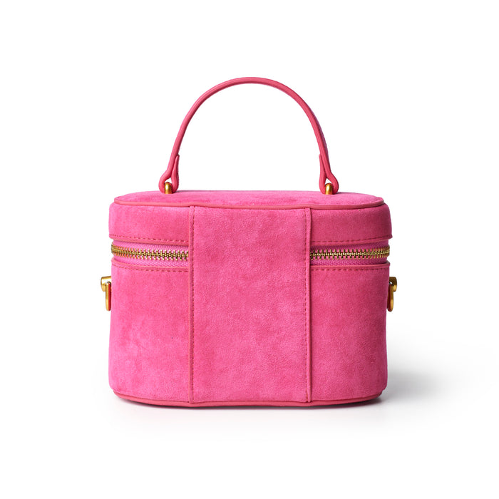 Hot pink mini suede vanity bag with dual zippers and a top handle, perfect for stylish storage on the go.