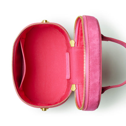 Hot pink mini suede vanity bag with a zip closure and a spacious interior featuring a single pocket.