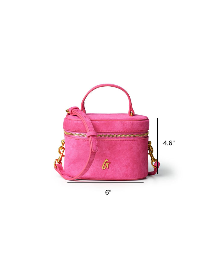 Hot pink mini suede vanity bag with gold accents, featuring a top handle and adjustable shoulder strap.