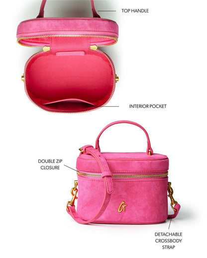 Hot pink mini suede vanity bag with top handle, double zip closure, and detachable crossbody strap. Interior pocket included.
