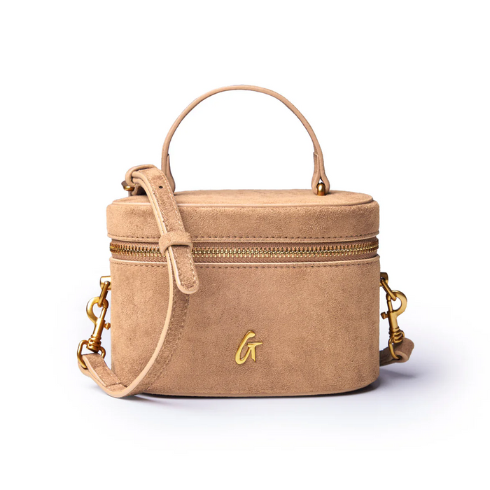 Tan mini suede vanity bag with a top handle, gold zipper, and detachable shoulder strap for stylish organization.