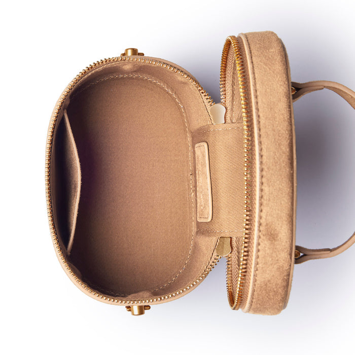 Tan mini suede vanity bag with a zip closure and spacious interior, perfect for organizing cosmetics and accessories.