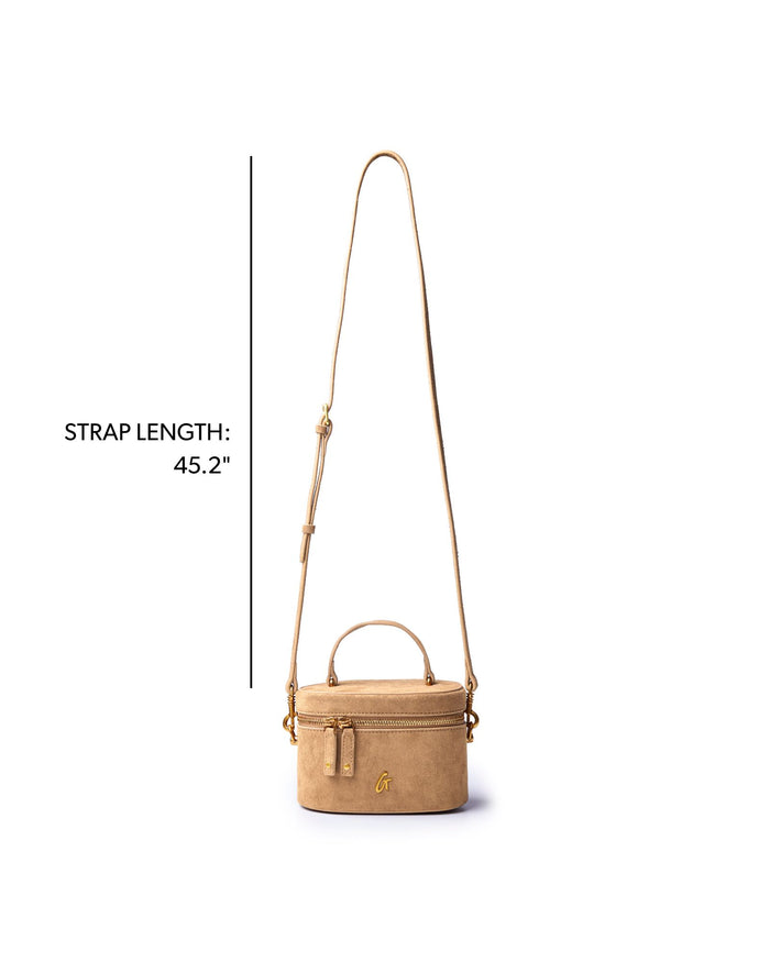 Tan mini suede vanity bag with a detachable strap, featuring a chic round design for stylish organization.