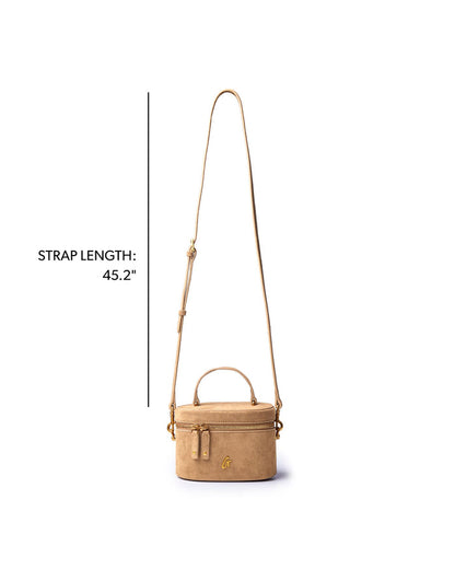 Tan mini suede vanity bag with a detachable strap, featuring a chic round design for stylish organization.
