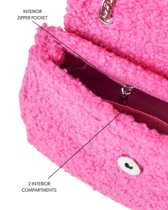 Hot pink mini teddy flap bag featuring an interior zipper pocket and two spacious compartments for organization.