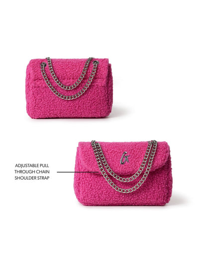 Hot pink mini teddy flap bag with adjustable chain shoulder strap, perfect for adding a pop of color to any outfit.