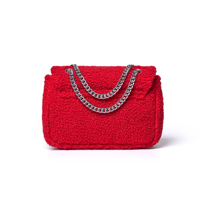 Red mini teddy flap bag with a textured exterior and silver chain straps, perfect for adding a pop of color to any outfit.