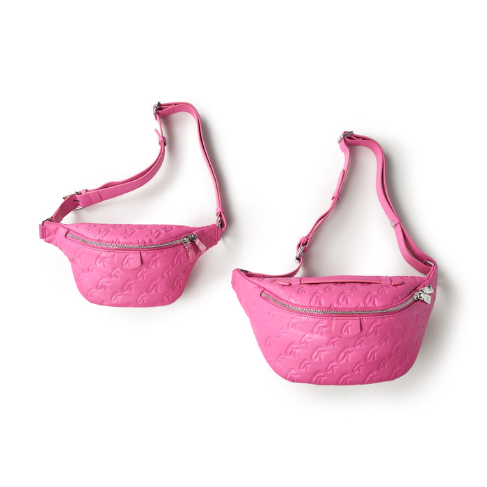 Two pink Monogram Fanny Packs with embossed logo pattern, silver zippers, and adjustable straps, displayed against a white background.