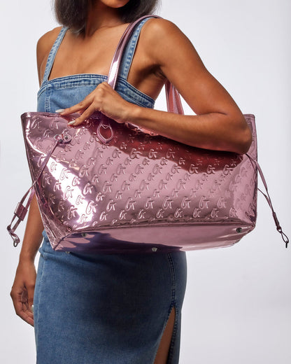 Metallic pink monogram glam tote with wristlet, featuring a stylish design and spacious interior for everyday use.