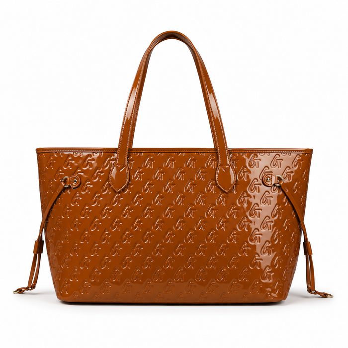 Monogram Glam Tote in mirror brown with embossed logo, dual handles, and detachable wristlet for stylish convenience.