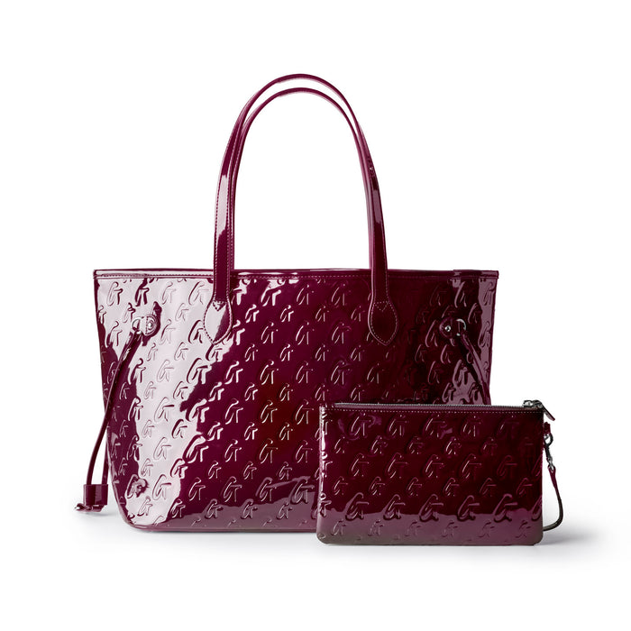 Glossy burgundy monogram tote bag with matching wristlet, perfect for stylish and functional everyday use.