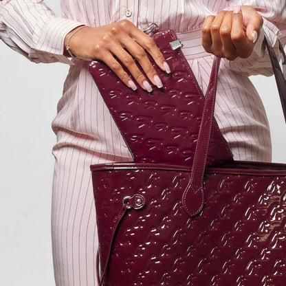 Mirror burgundy monogram glam tote with wristlet, showcasing a stylish and functional design for modern women.