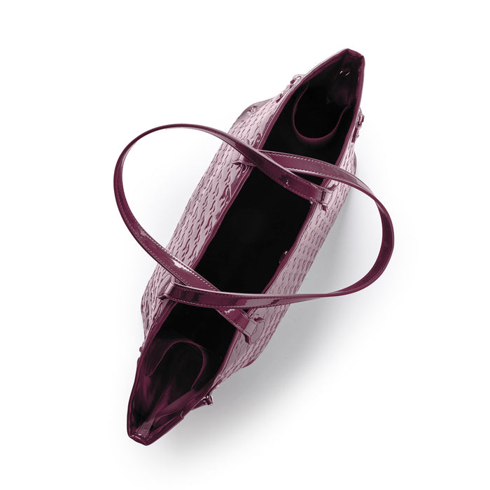 Monogram Glam Tote in mirror burgundy with dual handles and a matching wristlet, featuring a spacious interior.
