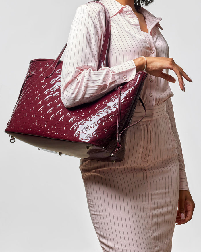 Monogram Glam Tote in mirror burgundy, featuring a stylish wristlet, perfect for affordable luxury.