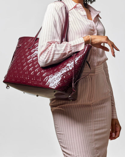 Monogram Glam Tote in mirror burgundy, featuring a stylish wristlet, perfect for affordable luxury.