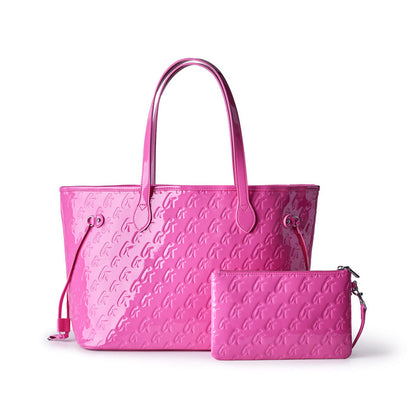 Hot pink monogram tote bag with matching wristlet, perfect for stylish and affordable luxury. Ideal for everyday use.