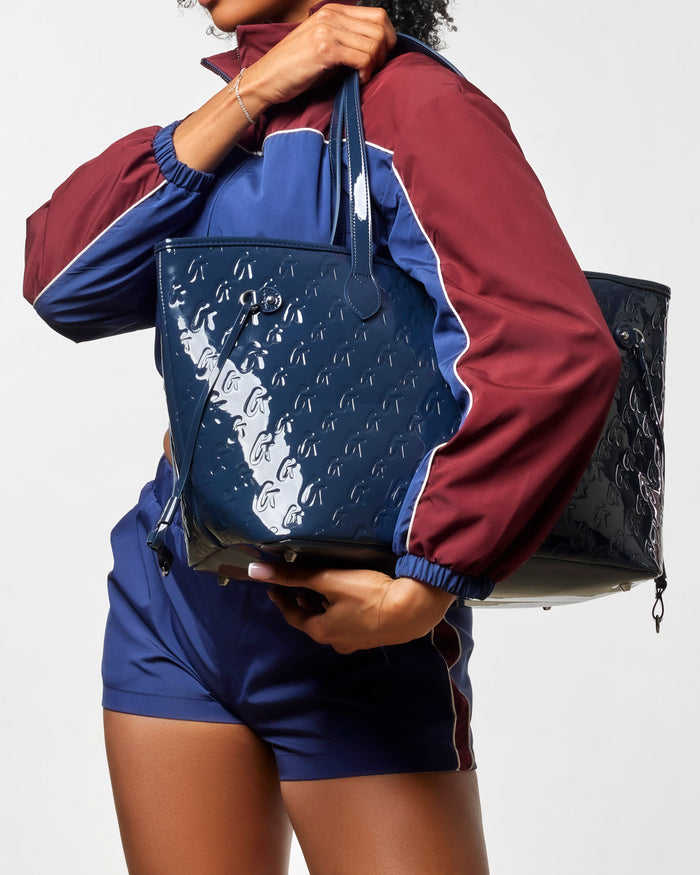 Navy monogram glam tote with wristlet, showcasing a glossy finish and stylish design, perfect for everyday use.
