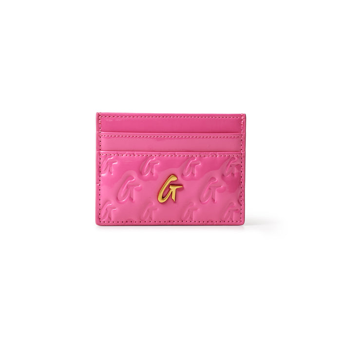 Pink mirror finish card holder with gold "G" logo and embossed "G" pattern, featuring multiple card slots.