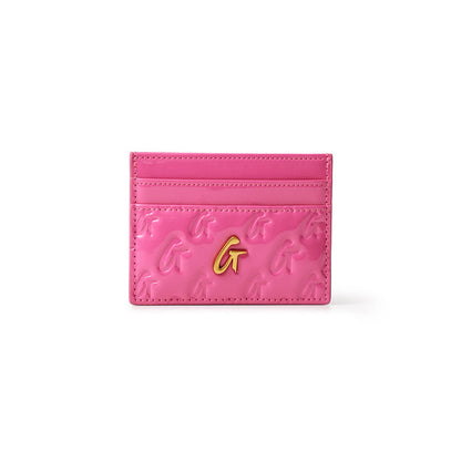 Pink mirror finish card holder with gold "G" logo and embossed "G" pattern, featuring multiple card slots.