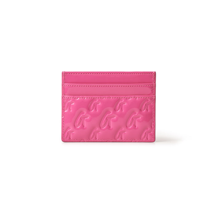 Pink mirror finish card holder with embossed gold "G" logo pattern and multiple card slots.