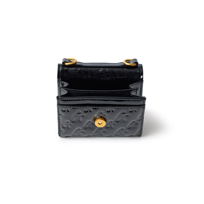 Black monogram gold compact wallet with a mirror finish, embossed with "G" pattern and gold hardware, open to show interior.