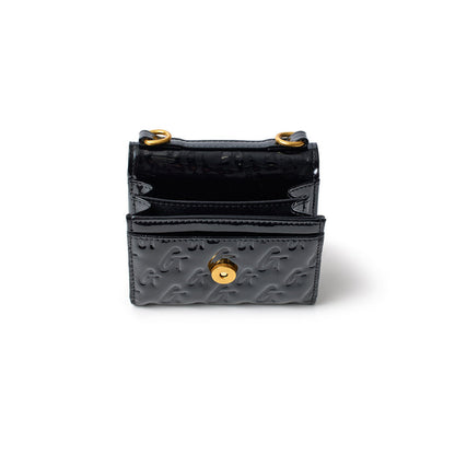Black monogram gold compact wallet with a mirror finish, embossed with "G" pattern and gold hardware, open to show interior.