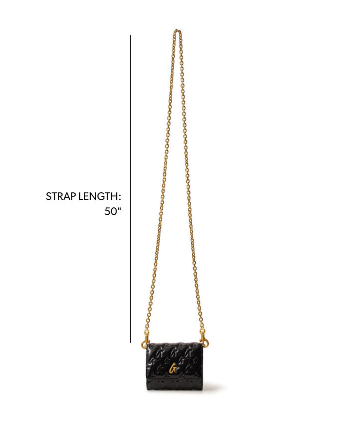 Compact black handbag with gold monogram, featuring a 50-inch chain strap for versatile styling.