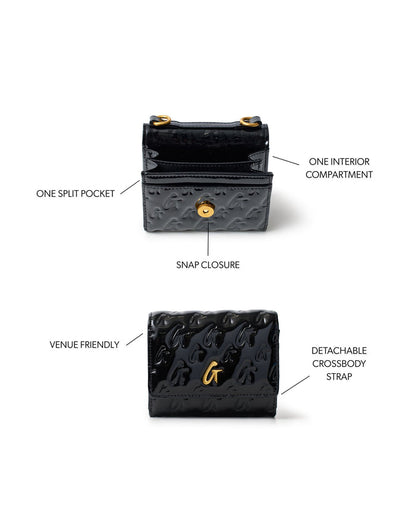 Compact black wallet on chain with gold monogram design, snap closure, and detachable crossbody strap.