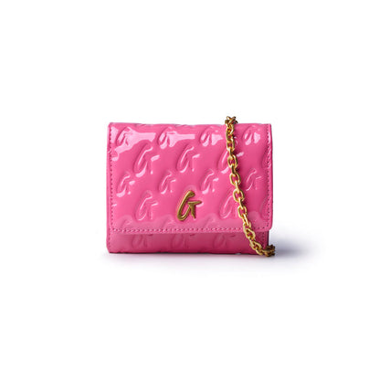 Hot pink compact wallet on chain with a glossy finish and gold monogram logo, perfect for stylish, affordable luxury.