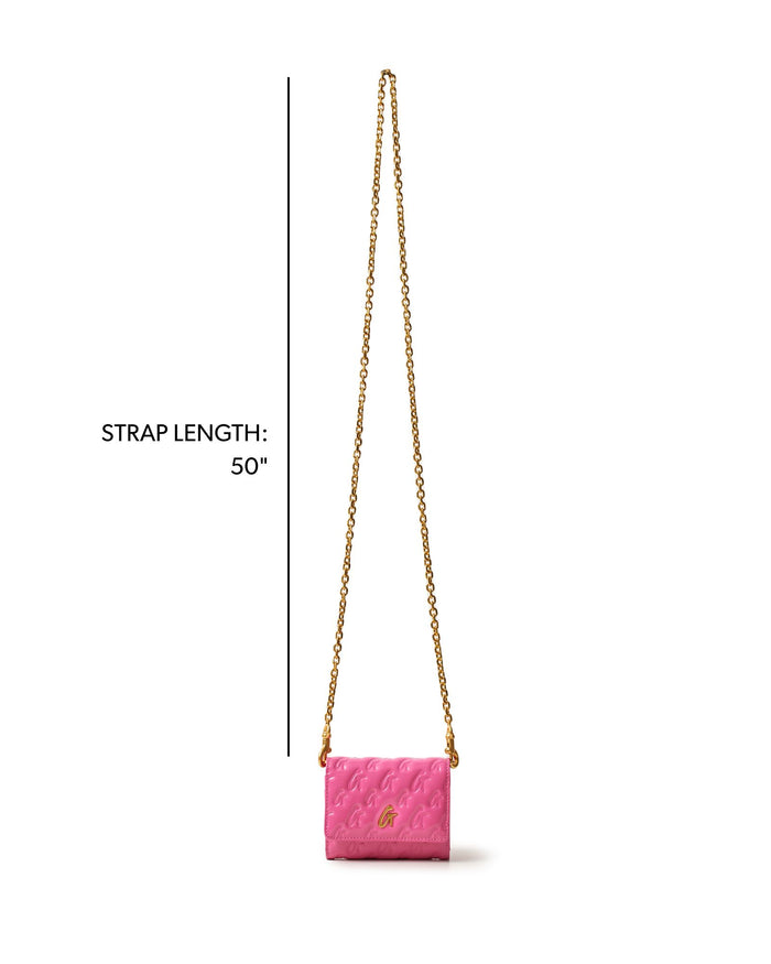 Hot pink compact wallet on a chain with a gold monogram design and a 50-inch strap for stylish versatility.