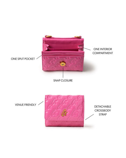 Hot pink compact wallet with monogram design, snap closure, split pocket, and detachable crossbody strap.