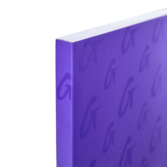 Close-up of a purple monogram notebook with a subtle, repeating cursive "G" pattern on the cover.