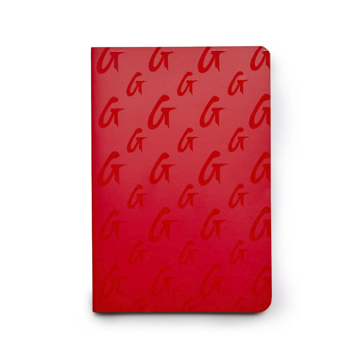 Red monogram notebook featuring a repeating G logo pattern, perfect for stylish note-taking and organization.