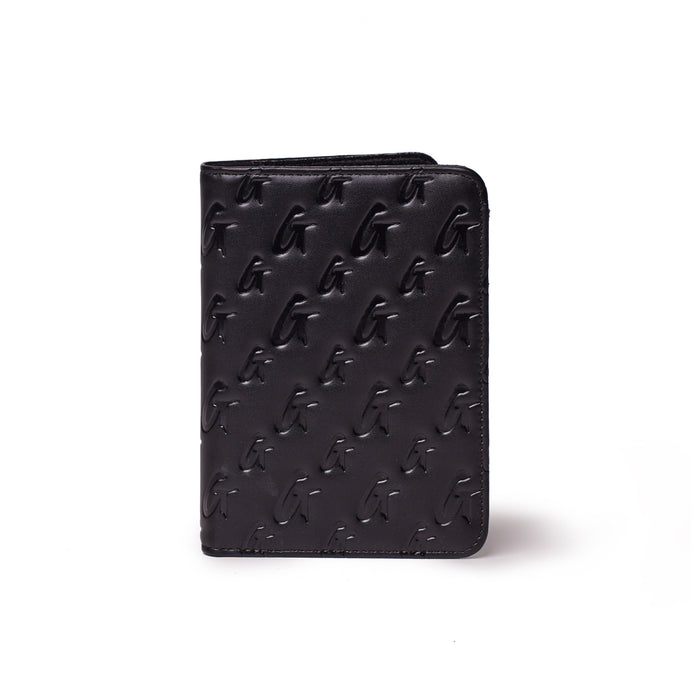 Black monogram passport holder with embossed G pattern, compact and stylish for travel accessories.