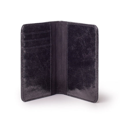 Black monogram passport holder with multiple card slots, open to show interior compartments.