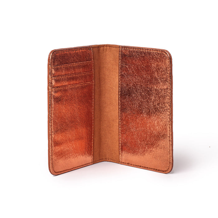 Brown monogram passport holder open, showing multiple card slots and a sleek, textured interior design.