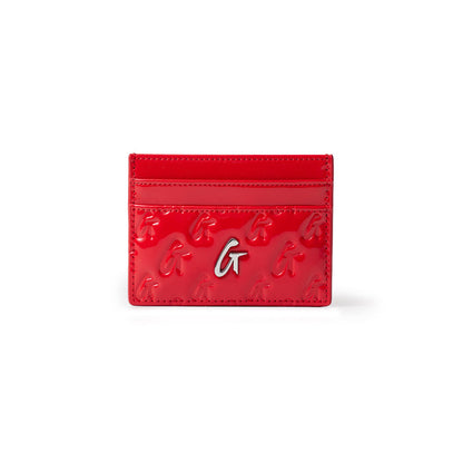 Red mirror-finish silver card holder with embossed G patterns and a silver logo, featuring multiple card slots.