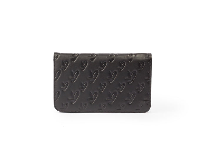Black Monogram Silver WOC wallet with embossed logo pattern on leather surface.