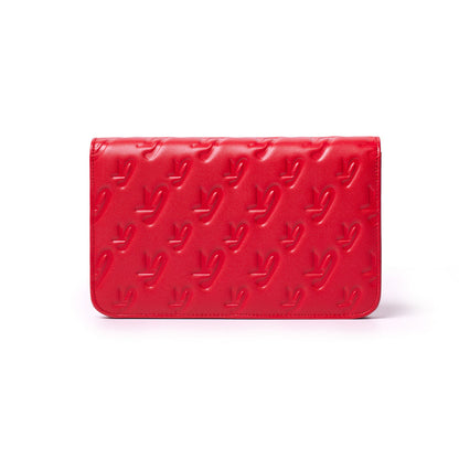Red Monogram Silver WOC wallet with embossed logo pattern on smooth leather surface.