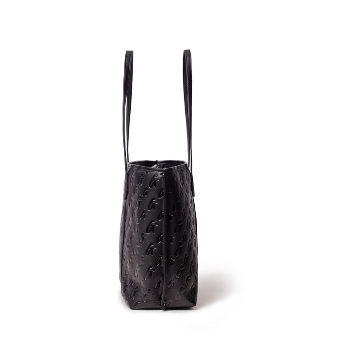 Black Monogram Sleek Tote bag with embossed logo pattern and long shoulder straps, stylish and spacious for everyday use.