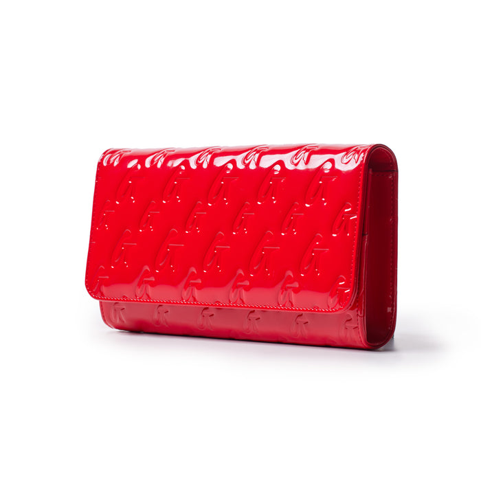Red glossy Monogram Travel Wallet with embossed logo pattern, sleek design, and mirror finish.